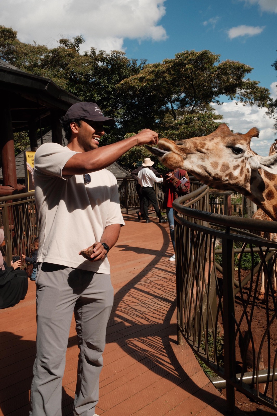 Ashwanth feeding a giraffe